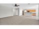 Open-concept living space featuring neutral paint, a ceiling fan, and an seamless flow into the kitchen area at 2605 W Darrel Rd, Phoenix, AZ 85041
