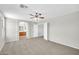 Spacious bedroom leading into a bathroom area, with neutral walls and soft carpeting throughout at 2605 W Darrel Rd, Phoenix, AZ 85041