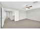 Large bedroom featuring neutral colored walls, soft carpet, a ceiling fan, and an attached bathroom at 2605 W Darrel Rd, Phoenix, AZ 85041