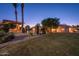 Expansive backyard with a well-manicured lawn, mature trees, a pool, and an outdoor kitchen area at 2661 E Birchwood Pl, Chandler, AZ 85249
