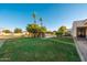 Spacious backyard with well-maintained lawn and desert landscaping offers ample room for outdoor activities at 2661 E Birchwood Pl, Chandler, AZ 85249