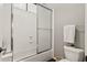 Bathroom featuring combination tub and shower with glass doors at 2661 E Birchwood Pl, Chandler, AZ 85249