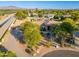 Stunning single-story home with mature trees, desert landscaping, and circular driveway in a scenic lakeside community at 2661 E Birchwood Pl, Chandler, AZ 85249