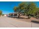 Home exterior with spacious driveway, desert landscaping and a three car garage at 2661 E Birchwood Pl, Chandler, AZ 85249