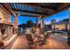 Relaxing outdoor patio with a stone fireplace, overhead pergola, and comfortable seating for entertaining at 2661 E Birchwood Pl, Chandler, AZ 85249