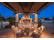 Cozy outdoor living space with a stone fireplace and comfortable seating under a wooden pergola at 2661 E Birchwood Pl, Chandler, AZ 85249