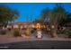Inviting front exterior showcasing desert landscaping and stone accents at dusk at 2661 E Birchwood Pl, Chandler, AZ 85249