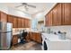 Spacious laundry room with stainless steel refrigerator, cabinets, and front load washer and dryer at 2661 E Birchwood Pl, Chandler, AZ 85249