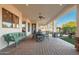 Spacious covered patio featuring brick flooring, comfortable seating, and views of the backyard at 2661 E Birchwood Pl, Chandler, AZ 85249