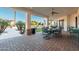 Covered patio with fan, outdoor furniture, and view of backyard and desert landscape at 2661 E Birchwood Pl, Chandler, AZ 85249