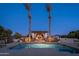 Stunning pool area with decorative stonework and a cozy seating area under a pergola at 2661 E Birchwood Pl, Chandler, AZ 85249