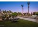 Luxurious pool area with outdoor seating, a pergola, and swaying palm trees offering a resort-like experience at 2661 E Birchwood Pl, Chandler, AZ 85249