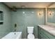 Well-lit bathroom with tub, shower, modern vanity, green tiling, and sophisticated fixtures at 2949 N 29Th St, Phoenix, AZ 85016