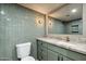 Stylish bathroom featuring green tiling, a marble countertop, and modern fixtures at 2949 N 29Th St, Phoenix, AZ 85016