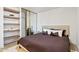 Comfortable bedroom with shelving, closet with mirrored doors, and neutral decor for a cozy retreat at 2949 N 29Th St, Phoenix, AZ 85016