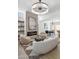 Bright open-concept living room with fireplace, modern lighting, and dining area creates a cozy yet elegant space at 2949 N 29Th St, Phoenix, AZ 85016