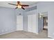 Bedroom features neutral carpet, ceiling fan, and ensuite bathroom at 2954 N Oregon St # 6, Chandler, AZ 85225