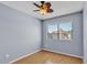 Cozy bedroom with natural light from the large window overlooking the nearby building and wood flooring at 2954 N Oregon St # 6, Chandler, AZ 85225