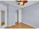 Bedroom with light blue walls, wood floors, closet, ceiling fan, and a door with a mirror attached at 2954 N Oregon St # 6, Chandler, AZ 85225