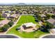 Aerial view of community park showcasing shaded picnic areas and playground in a lush green setting at 3022 E Santa Fe Ln, Gilbert, AZ 85297