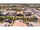An aerial view of the property features lush lawn, desert landscape, and a glimpse of the inviting pool at 3022 E Santa Fe Ln, Gilbert, AZ 85297