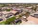 An aerial view shows the backyard, including a well maintained lawn, desert landscaping, and nearby pool at 3022 E Santa Fe Ln, Gilbert, AZ 85297