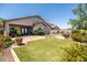 Spacious backyard has a synthetic lawn, landscaped areas, and covered patio, perfect for outdoor entertaining and relaxation at 3022 E Santa Fe Ln, Gilbert, AZ 85297