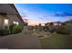Twilight view of backyard featuring a manicured lawn, landscaped area, and pavers at 3022 E Santa Fe Ln, Gilbert, AZ 85297