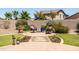 Paver patio with outdoor seating area and manicured landscaping, surrounded by block fence at 3022 E Santa Fe Ln, Gilbert, AZ 85297