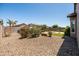 Expansive xeriscaped backyard with a circular patio, seating area, and lush landscaping at 3022 E Santa Fe Ln, Gilbert, AZ 85297