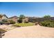 View of the landscaped backyard with pavers, lawn, decorative bushes, and a privacy wall at 3022 E Santa Fe Ln, Gilbert, AZ 85297