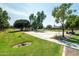 Community basketball court with well-maintained concrete surface, trees, benches, and manicured lawns at 3022 E Santa Fe Ln, Gilbert, AZ 85297