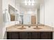 Bathroom vanity with double sinks, large mirror, and ample counter space perfect for a shared bathroom at 3022 E Santa Fe Ln, Gilbert, AZ 85297
