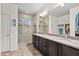 Modern bathroom featuring double sinks, granite countertops, and a tiled shower at 3022 E Santa Fe Ln, Gilbert, AZ 85297