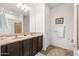 Bright bathroom featuring double sinks, dark wood cabinetry, and tile flooring at 3022 E Santa Fe Ln, Gilbert, AZ 85297