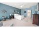 Comfortable bedroom featuring blue walls, neutral carpet, and a cozy, inviting atmosphere at 3022 E Santa Fe Ln, Gilbert, AZ 85297