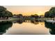 Picturesque view of the community pond with gazebo and walking paths at sunset at 3022 E Santa Fe Ln, Gilbert, AZ 85297
