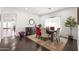 Elegant dining room featuring a wooden table with seating for six, dark wood floors, and a buffet at 3022 E Santa Fe Ln, Gilbert, AZ 85297