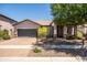 Well-maintained single-story home featuring a desert landscape, a two-car garage, and a covered entryway at 3022 E Santa Fe Ln, Gilbert, AZ 85297