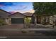 Charming single-story home featuring a desert landscape, a two-car garage, and a covered entryway at 3022 E Santa Fe Ln, Gilbert, AZ 85297
