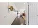 Long hallway with dark wood floors, white walls, and decorative accents leading to the dining room at 3022 E Santa Fe Ln, Gilbert, AZ 85297