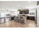 Spacious kitchen with dark cabinets, a center island with seating, and stainless steel appliances at 3022 E Santa Fe Ln, Gilbert, AZ 85297