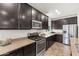 Modern kitchen featuring stainless steel appliances, granite counters, and dark wood cabinetry at 3022 E Santa Fe Ln, Gilbert, AZ 85297
