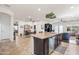 Bright and airy living area with an open kitchen, casual dining, and a comfortable seating arrangement at 3022 E Santa Fe Ln, Gilbert, AZ 85297