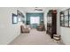 Well-lit living room highlighting comfortable seating, neutral carpet, and tasteful decor at 3022 E Santa Fe Ln, Gilbert, AZ 85297