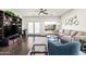 Cozy living room featuring hardwood floors, a comfortable couch, accent chair and shelving at 3022 E Santa Fe Ln, Gilbert, AZ 85297