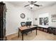 Bright office space with a ceiling fan, natural light, a wooden desk, and built-in storage at 3022 E Santa Fe Ln, Gilbert, AZ 85297