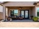 Inviting covered patio features brick pavers, comfortable seating and a ceiling fan for a relaxing outdoor experience at 3022 E Santa Fe Ln, Gilbert, AZ 85297