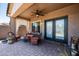 Inviting covered patio features brick pavers, comfortable seating and a ceiling fan for a relaxing outdoor experience at 3022 E Santa Fe Ln, Gilbert, AZ 85297