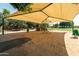 Community playground with shade structure, play equipment, and soft sand surface for to enjoy at 3022 E Santa Fe Ln, Gilbert, AZ 85297